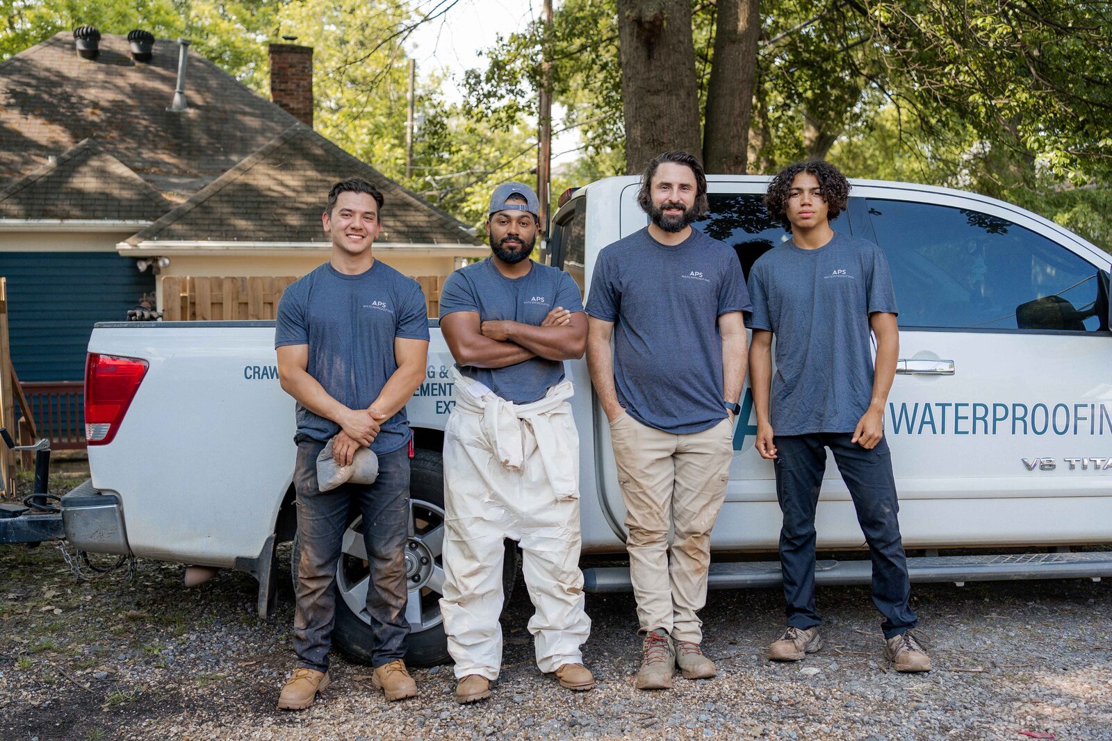 APS Waterproofing team standing in front of company truck