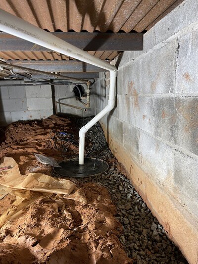 Man knelt down preparing for waterproofing services Atlanta